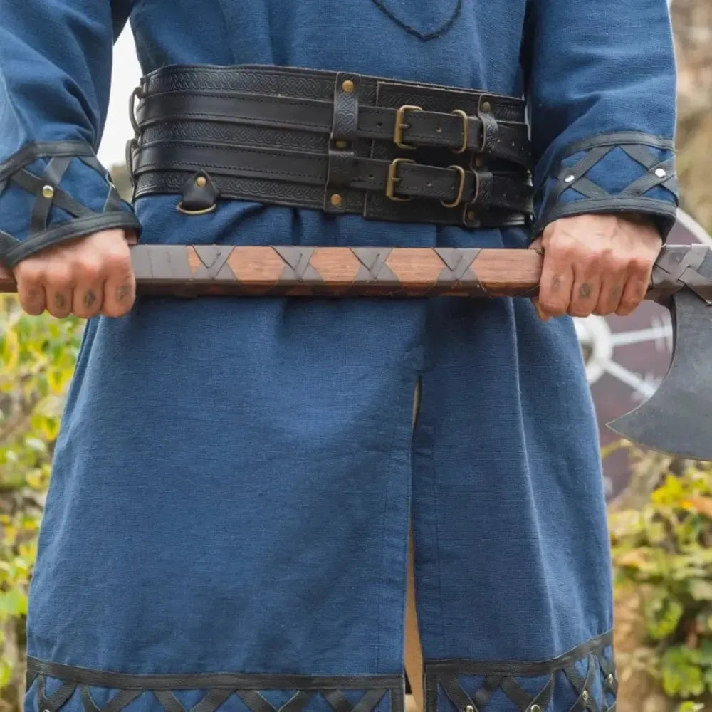 Black double-design thick leather Viking belt with buckles, worn over a blue tunic, holding an axe.