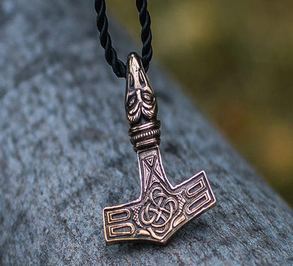 Viking Thor's Hammer Mjolnir bronze pendant with raven head detail on a black cord.
