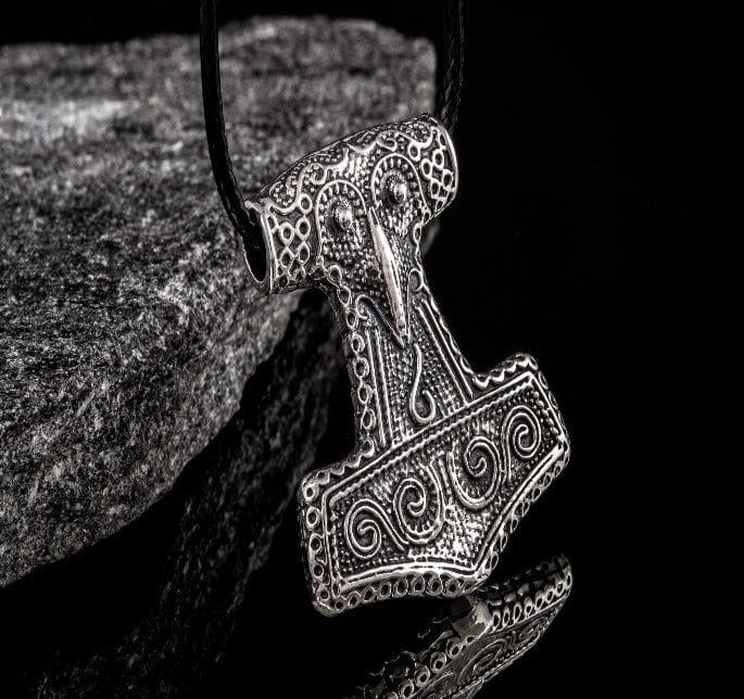 Viking Thor's Hammer Mjolnir pendant, intricately detailed silver-tone metal on a black cord.