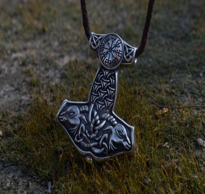 Sterling silver Viking Thor's Hammer Mjolnir pendant with intricate Norse knotwork and goat designs on a brown cord.
