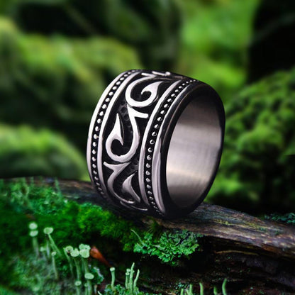 Wide titanium steel Viking ring with intricate Nordic swirl and dot patterns.