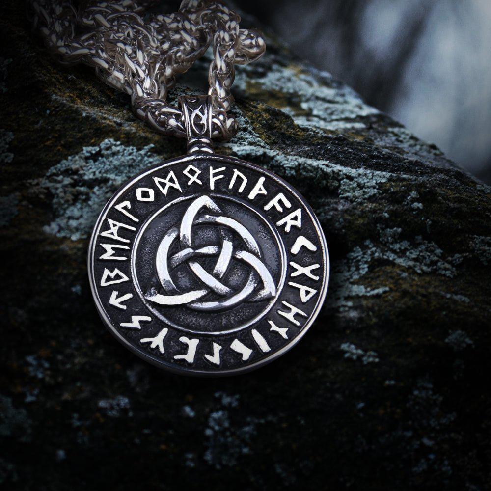 Viking silver Triquetra Futhark rune eternity necklace with intricate knotwork on a dark, textured surface.