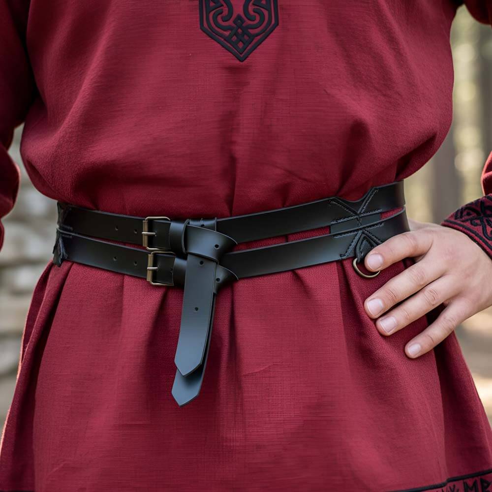 Black faux leather Viking twin utility belt with brass buckles over a red tunic.