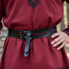 Black faux leather Viking twin utility belt with brass buckles over a red tunic.