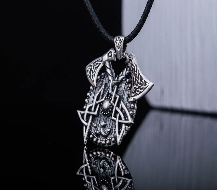 Sterling silver Viking axes and shield necklace with intricate Norse knotwork on a black cord.
