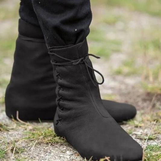 Black low-cut Viking boots with lace-tied faux leather, worn over pants.