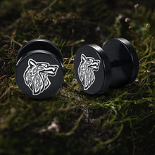 Black Viking Fenrir wolf stud earrings with white Celtic knot design on moss.