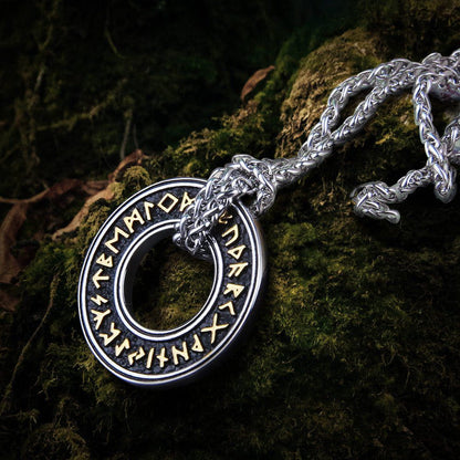 Viking Futhark runic circle pendant, silver-tone metal with gold-colored runes, on a thick chain.