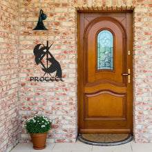 Black metal Viking Protect wall sign with raven design on a brick wall.