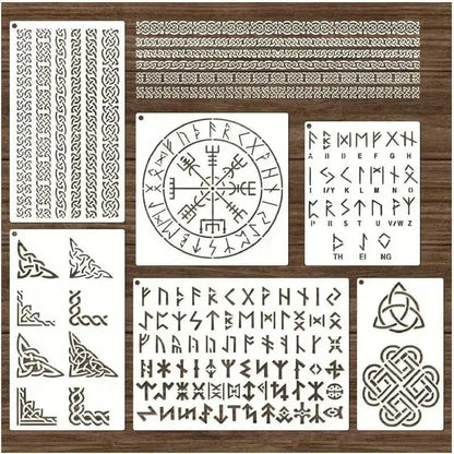 White Viking rune stencils with Norse symbols, Celtic borders, and alphabet designs on a wooden background.