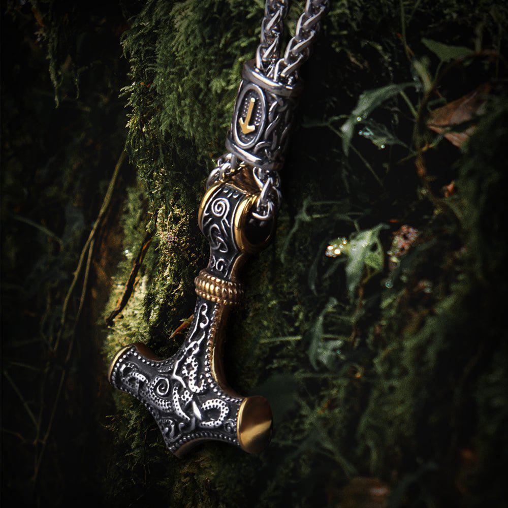 Viking Thor's Hammer pendant, intricate silver and gold, rune details, on a dark mossy background.