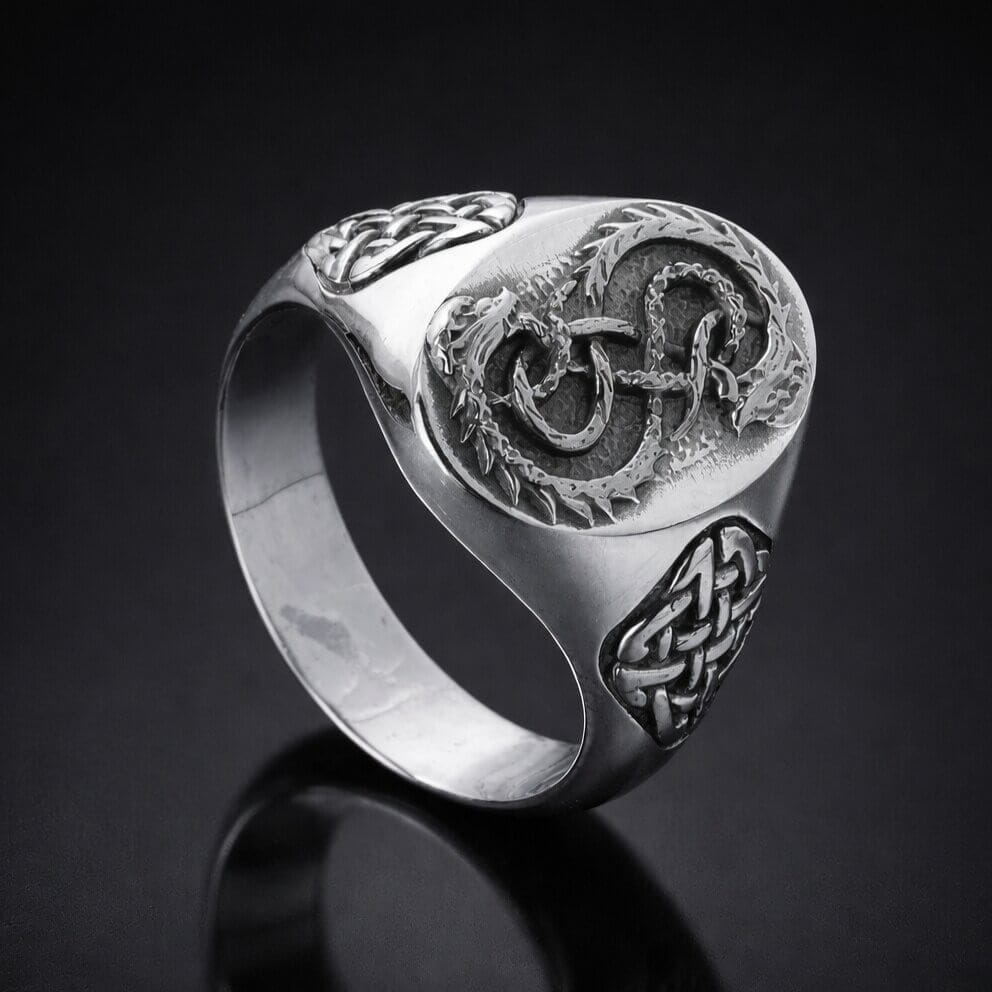 Viking silver signet ring with intricate Celtic knot and serpent design.