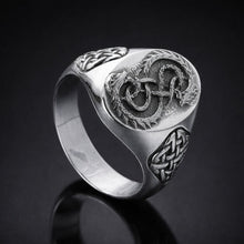 Viking silver signet ring with intricate Celtic knot and serpent design.