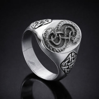 Viking silver signet ring with intricate Celtic knot and serpent design.