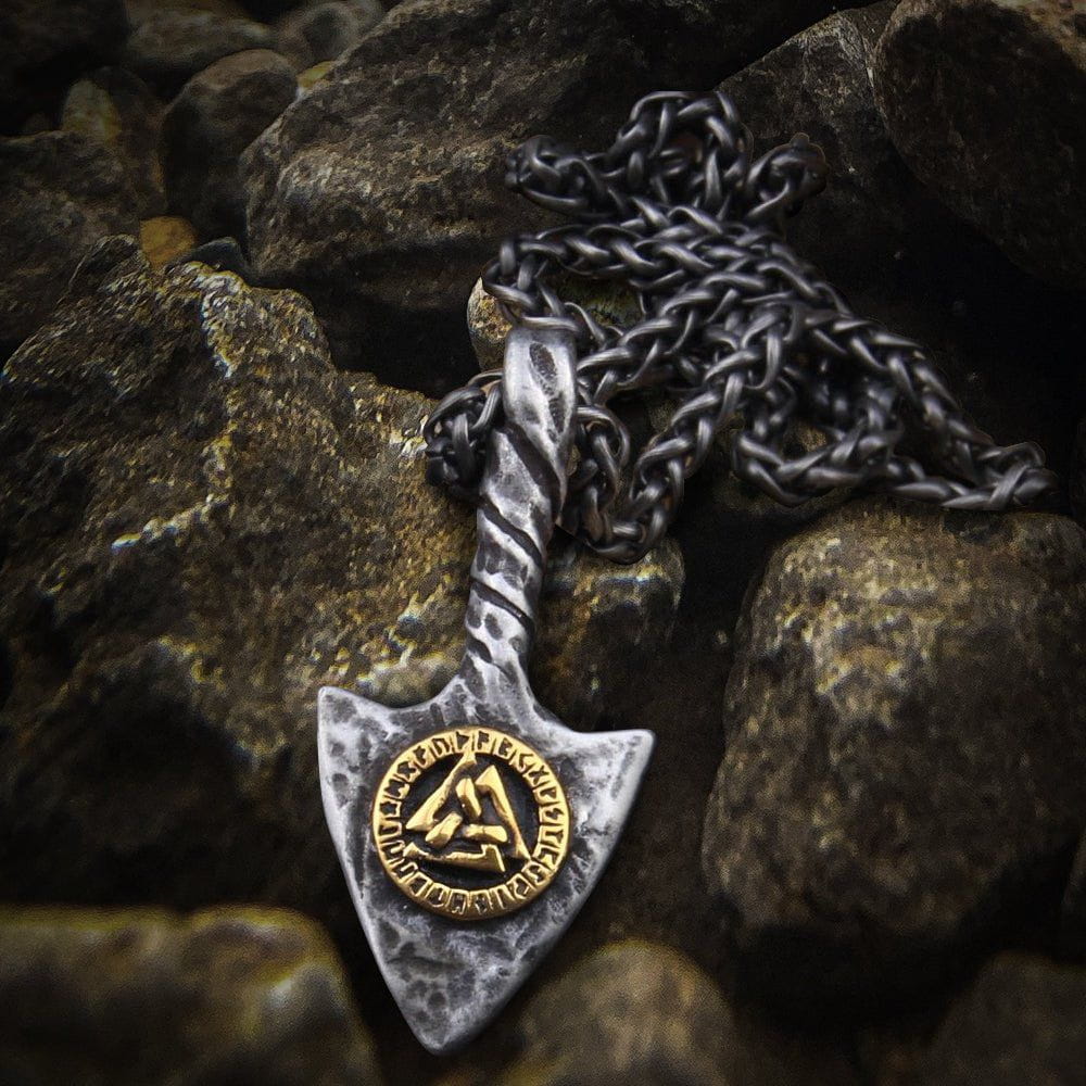 Viking spearhead amulet necklace with a gold Valknut symbol on a textured silver pendant and dark chain.