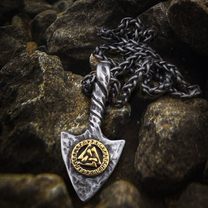 Viking spearhead amulet necklace with a gold Valknut symbol on a textured silver pendant and dark chain.