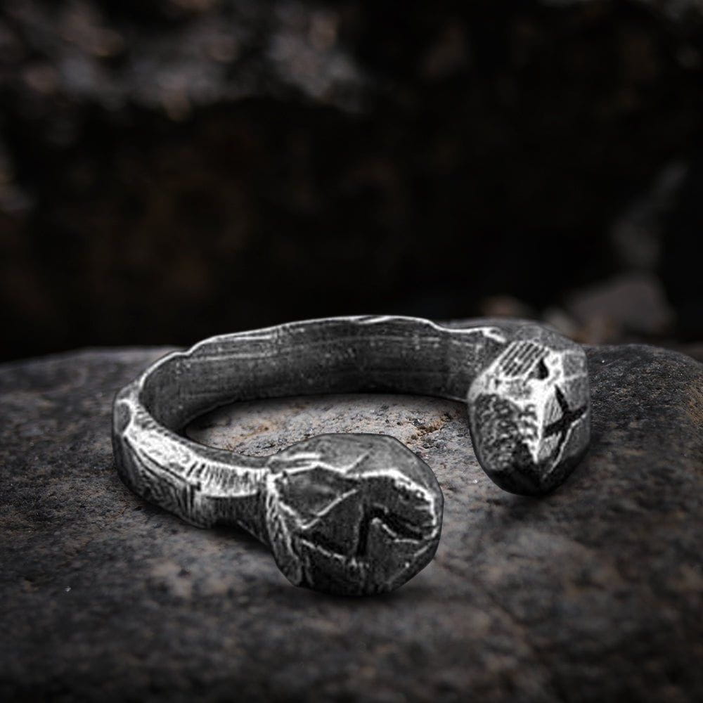 Viking stainless steel rune cuff ring with dark, textured finish on a stone.