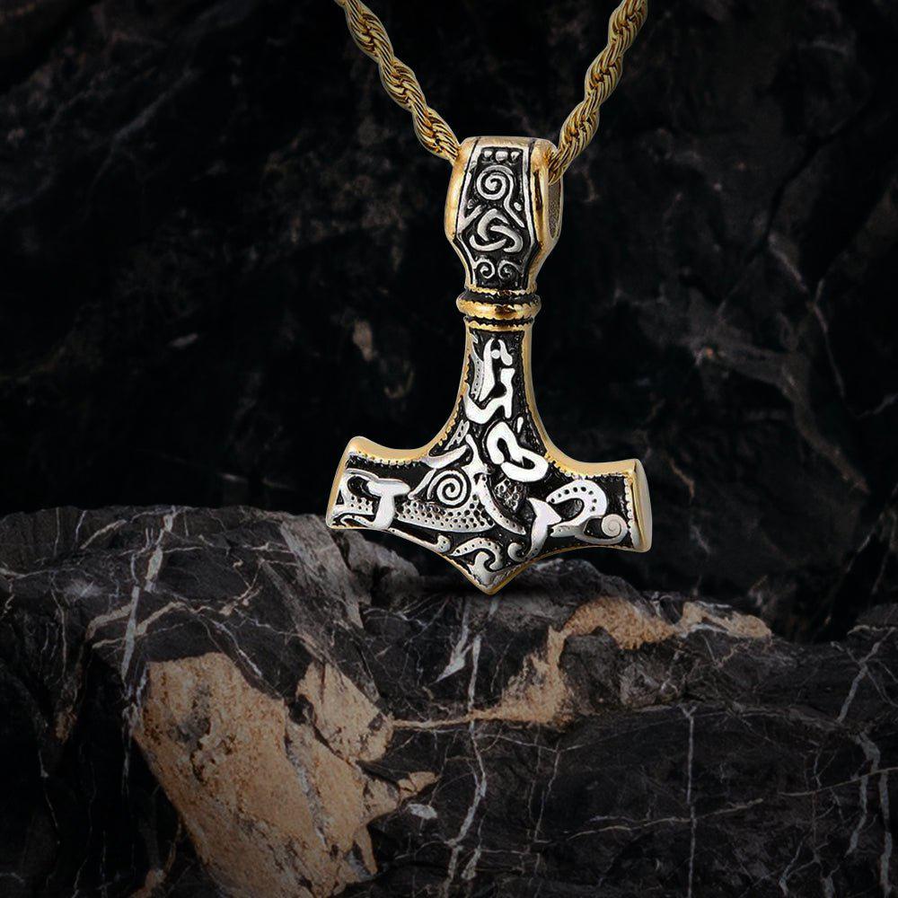 Viking Thor's Hammer necklace, gold and silver-toned, with intricate Norse knotwork on a braided chain.