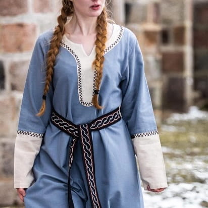 Viking black braided tie belt on a woman wearing a blue dress with cream trim.