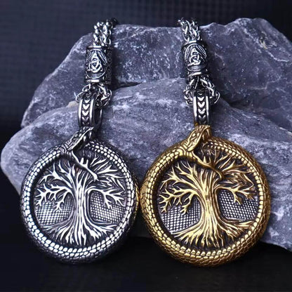Viking Tree of Life stainless steel necklaces, one silver, one gold, with serpent and Celtic knot details.