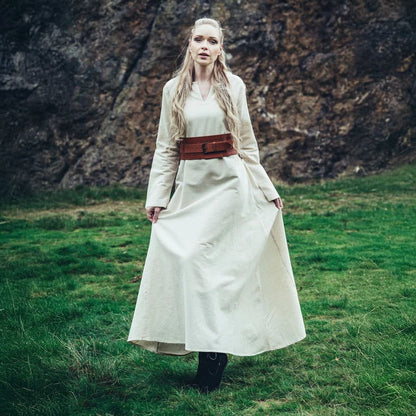 Viking woman in a long, natural white cotton underdress with a brown leather belt.