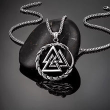 Viking Valknut Dragon stainless steel necklace on a dark stone.