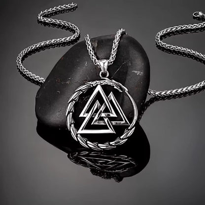 Viking Valknut Dragon stainless steel necklace on a dark stone.