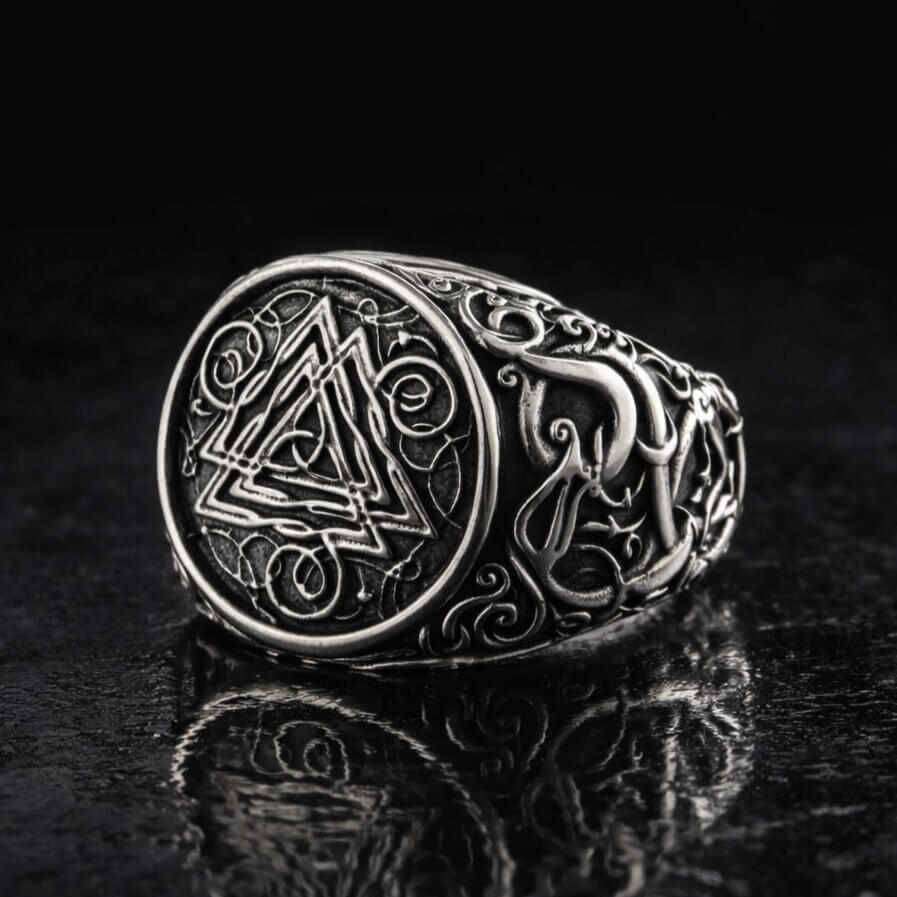 Viking Valknut ornamental silver signet ring with intricate knotwork on a dark background.