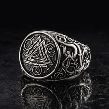 Viking Valknut ornamental silver signet ring with intricate knotwork on a dark background.