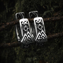 Viking Valknut Rune silver stainless steel hoop earrings on a mossy branch.
