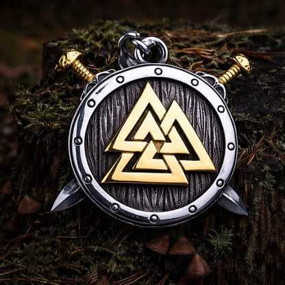 Viking Valknut shield pendant: silver and gold, with crossed swords, on a mossy tree stump.