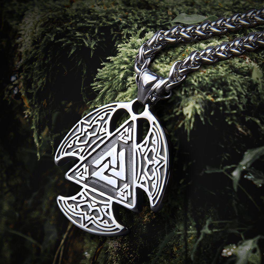 Silver Viking Valknut Talisman pendant with intricate knotwork on a thick chain, resting on moss.