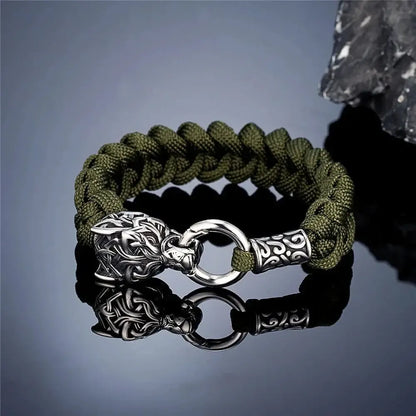 Viking wolf head bracelet with olive green paracord rope and silver-toned clasp.
