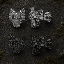 Viking wolf head stud earrings in black and silver finishes, featuring intricate Celtic knotwork.