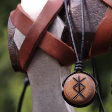Handmade wooden Viking pendant with engraved protection rune necklace on black cord.