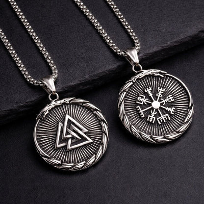 Two Viking Valknut Vegvisir Compass Necklaces on slate - round medallions with Odin's knot and Nordic wayfinder symbols featuring sunray texture and braided border