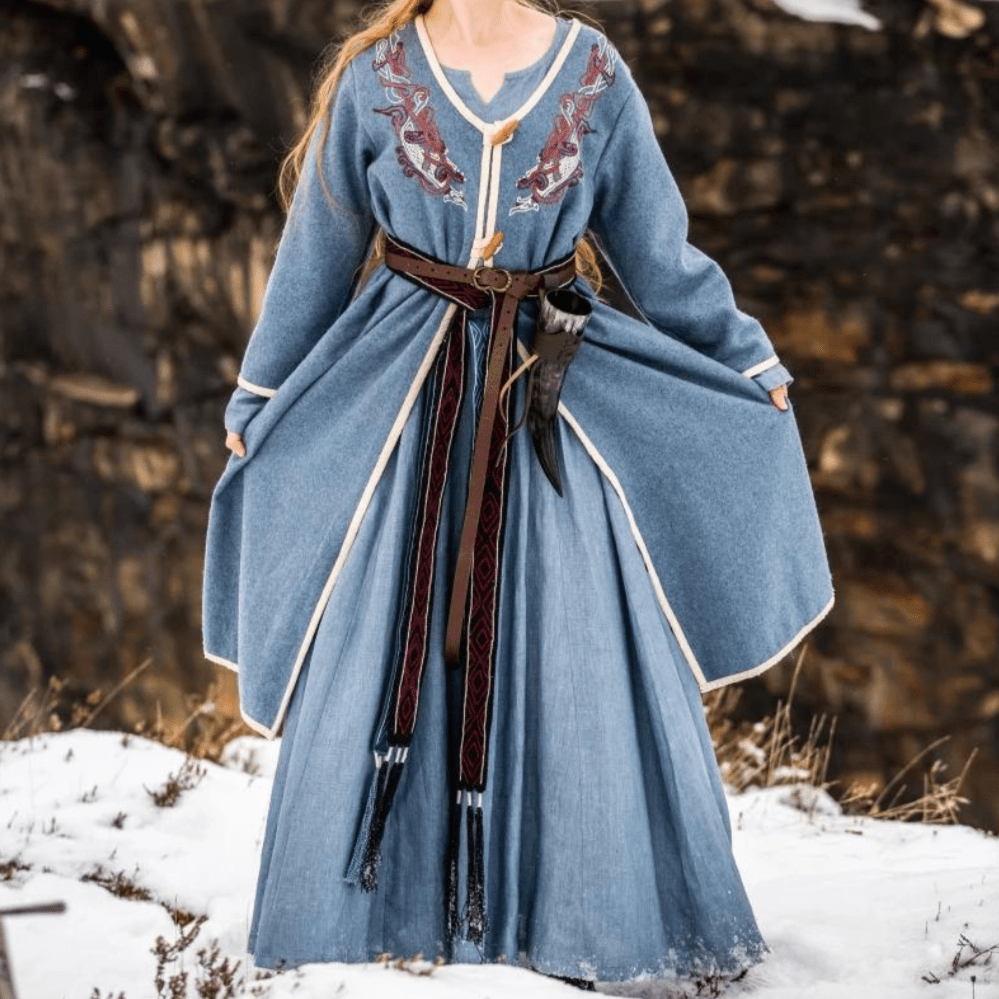 Women's blue wool Viking coat with Urnes embroidery, long sleeves, and a brown belt.