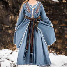 Women's blue wool Viking coat with Urnes embroidery, long sleeves, and a brown belt.