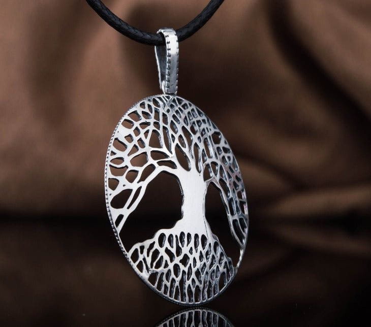 Sterling silver oval Viking Yggdrasil World Tree pendant with intricate cutout design on a black cord.