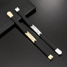 Genuine black leather Viking bracelets in gold-plated and stainless steel finishes – rectangular metal plates with engraved Nordic Tyr arrow and feather fletching design – magnetic clasp closures – men's Norse warrior wristbands displayed on black leather surface