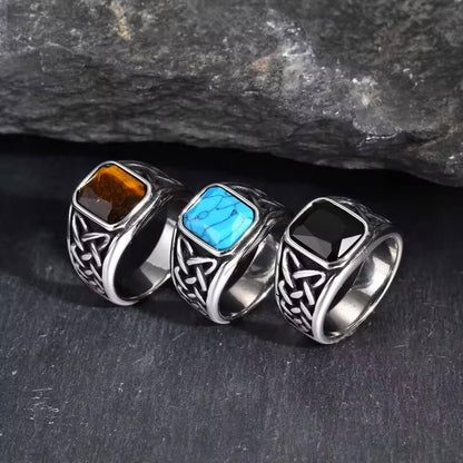 Viking Celtic knot stainless steel rings with brown, blue, and black stones.