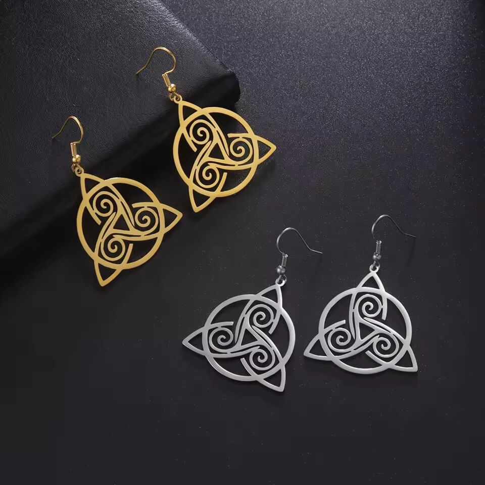 Celtic triquetra and triskelion dangle earrings in gold and silver stainless steel with openwork cutout design on fish hook wires