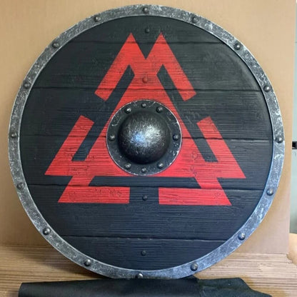 Black wooden Viking round shield with a red Valknut symbol, iron boss, and studded metal rim.