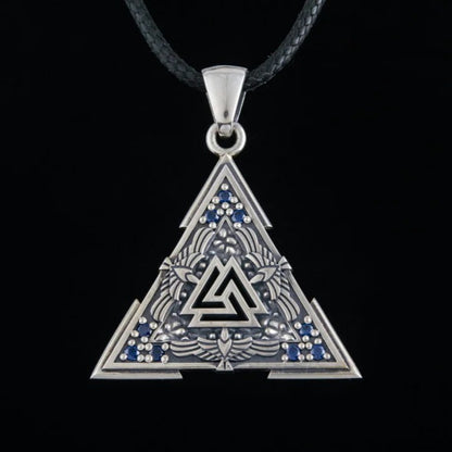 Sterling silver Viking Valknut pendant with blue gems on a black cord.