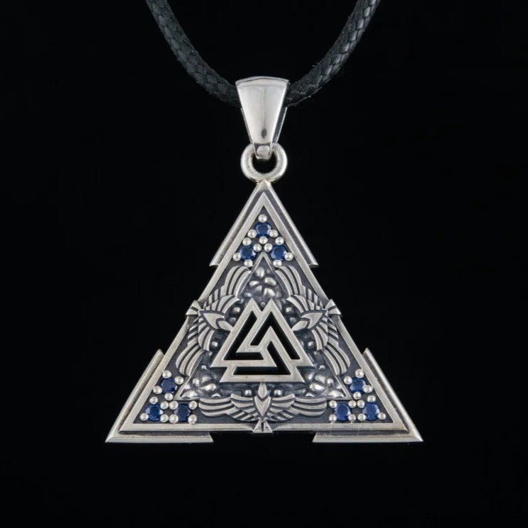 Sterling Silver Viking Raven Valknut Necklace - triangular pendant with interlocking triangle symbol, embossed raven wings, blue gemstone accents, and black braided cord