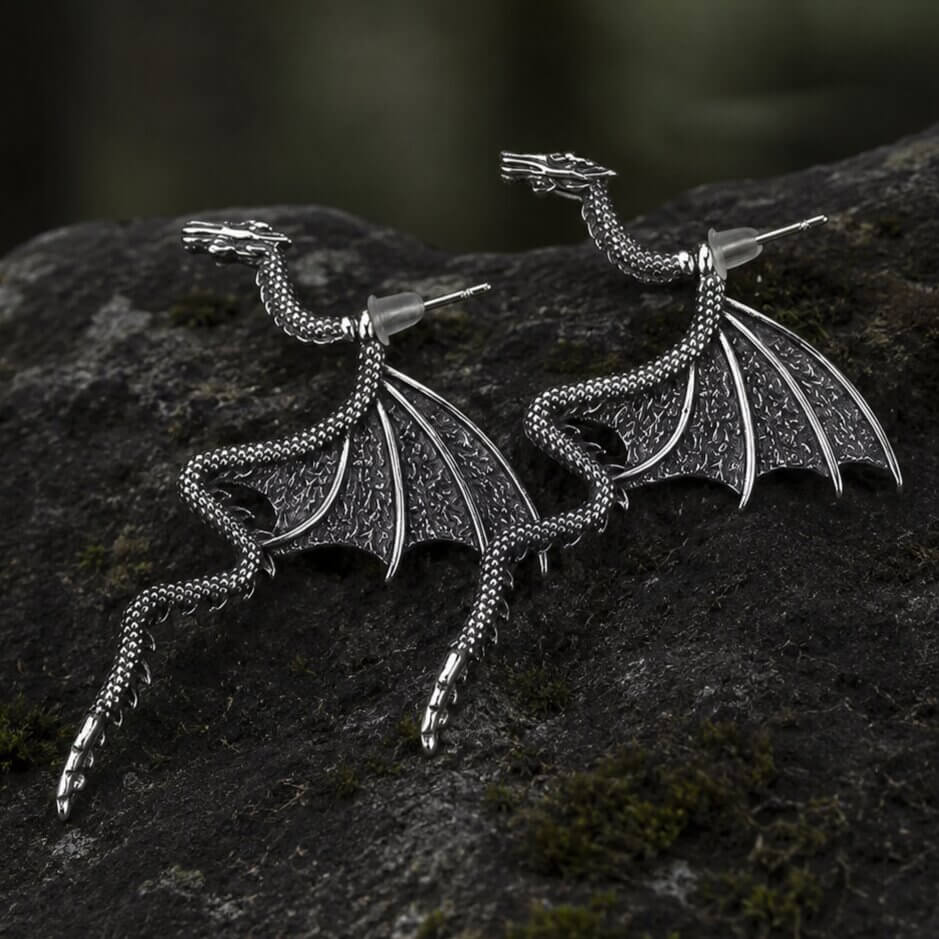 Silver Viking dragon earrings with detailed wings, scaled body, and Norse Nidhogg design