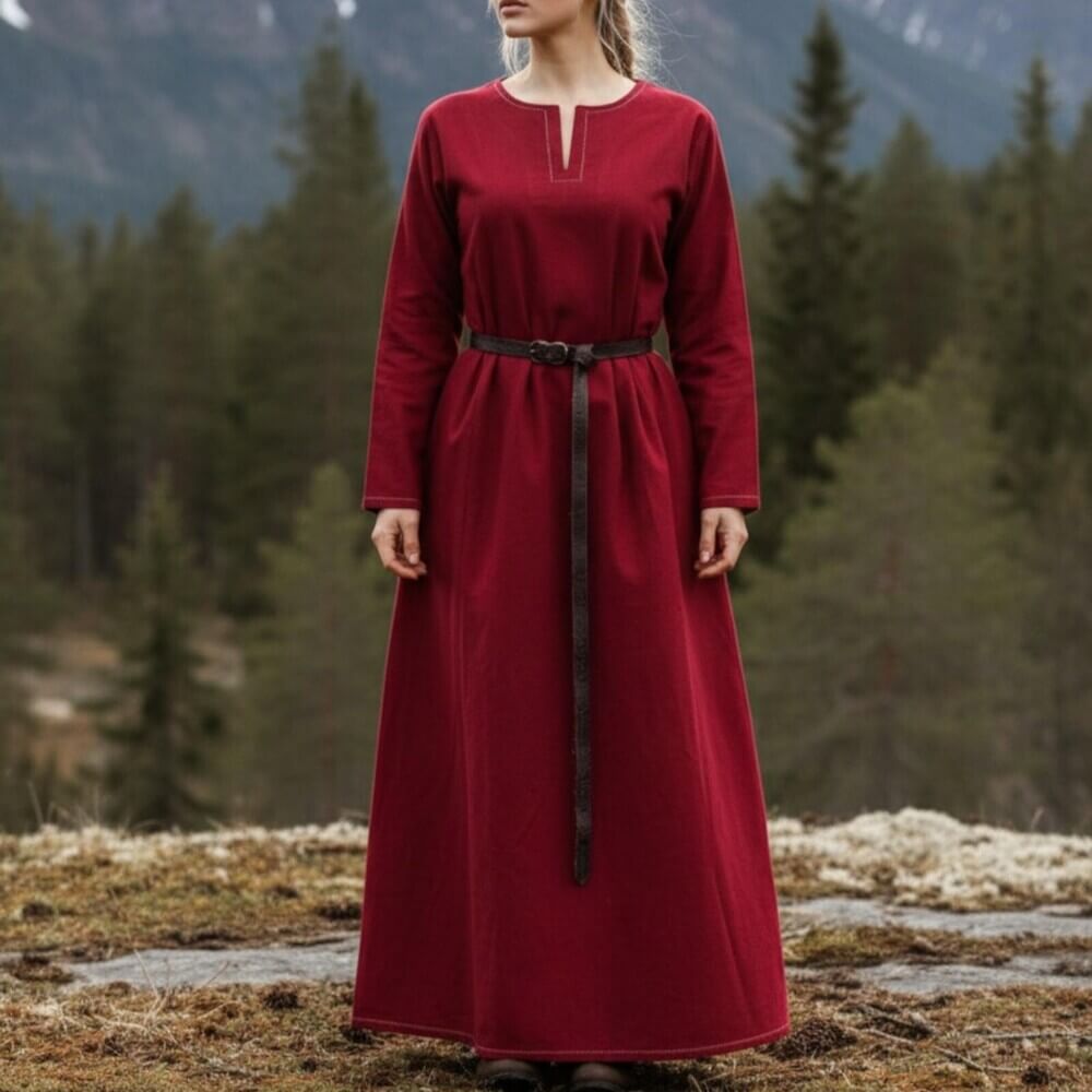 Woman wearing Viking Dress or Underdress - Rich Red, long crimson gown with simple neckline and brown belt, standing outdoors.