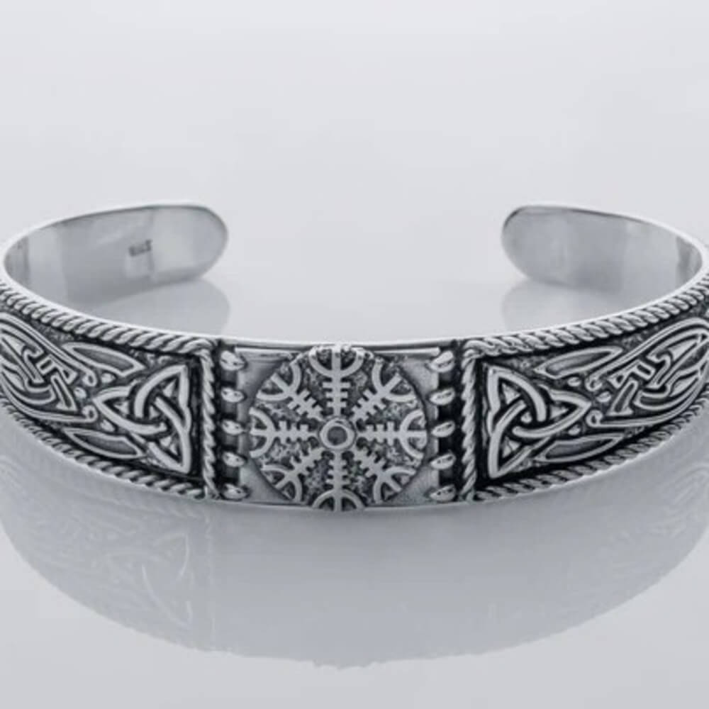 Silver Viking cuff bracelet featuring the Helm of Awe symbol at the center with carved knotwork panels on each side.