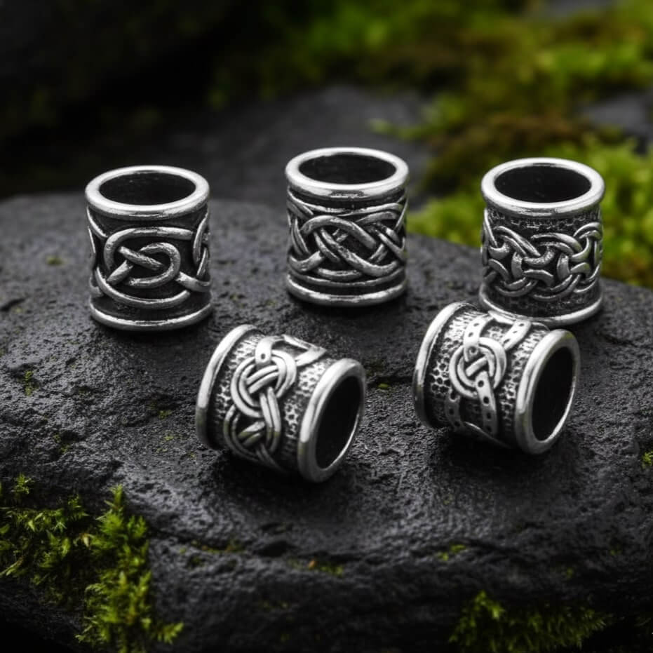 Five-piece Viking Knotwork Shield Beard Beads Set with intricate patterns displayed on vibrant green moss.