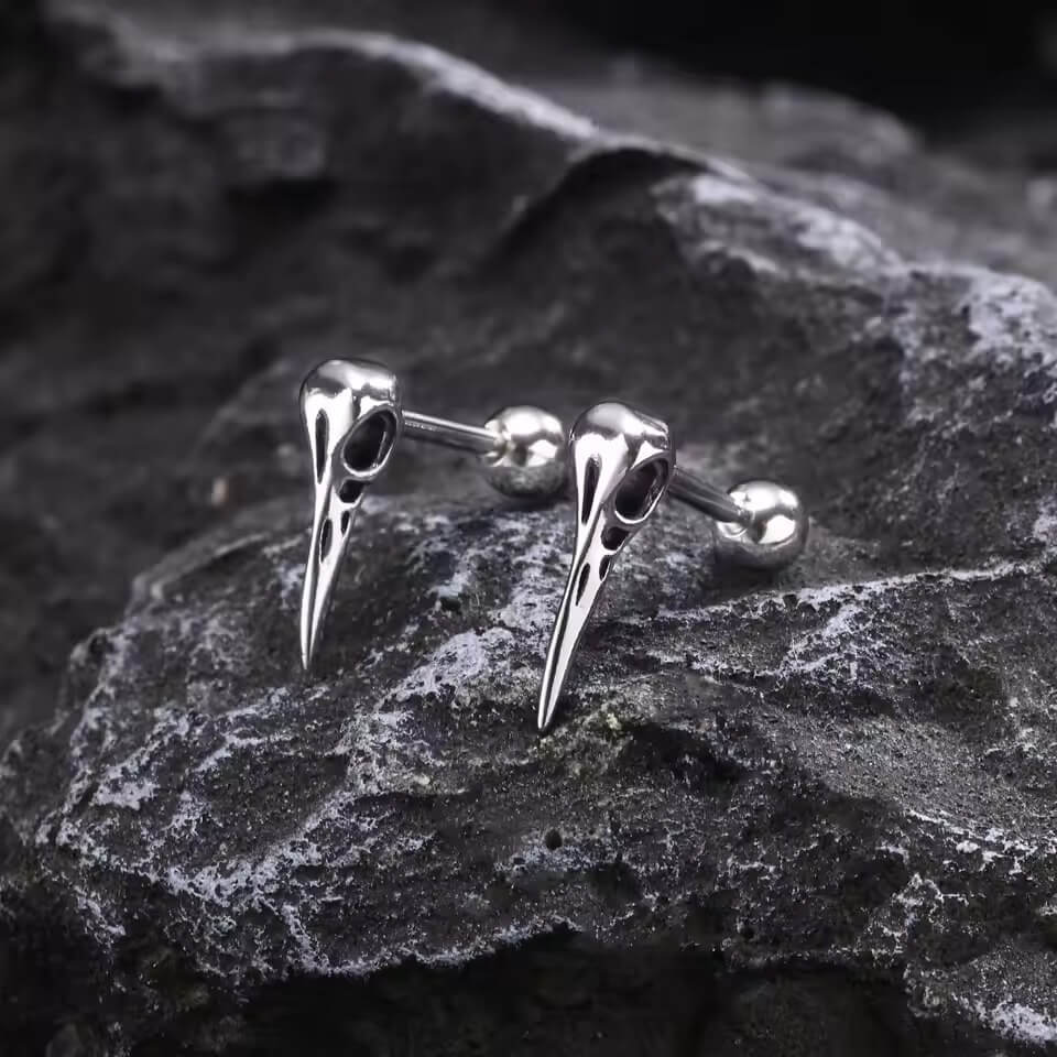 Silver Viking raven skull stud earrings with detailed beak and Odin's ravens design